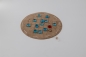 Preview: Fox and geese board game on a round beige leather playing field with a red fox and 13 geese in light blue, turquoise